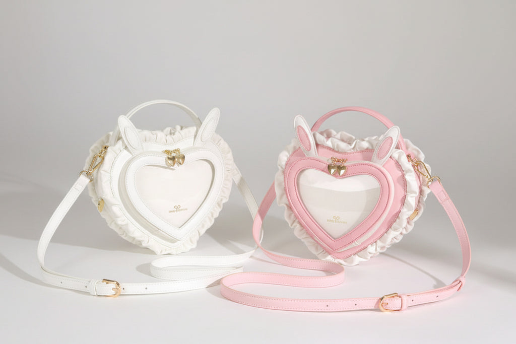 Heart-shaped handbag with pink strap on a light background